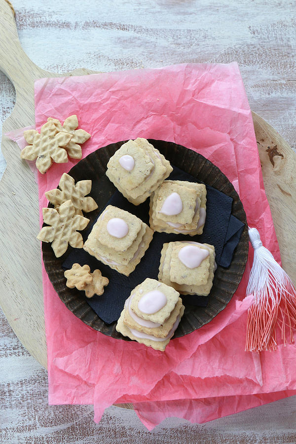 Gluten-free Layered Biscuits With Pink Icing And Waffle Biscuits On Pink Tissue Paper Photograph by Regina Hippel