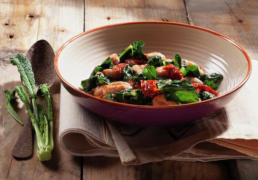Gnocchi With Black Cabbage, Dried Peppers And Tomato Sauce Photograph by Blueberrystudio