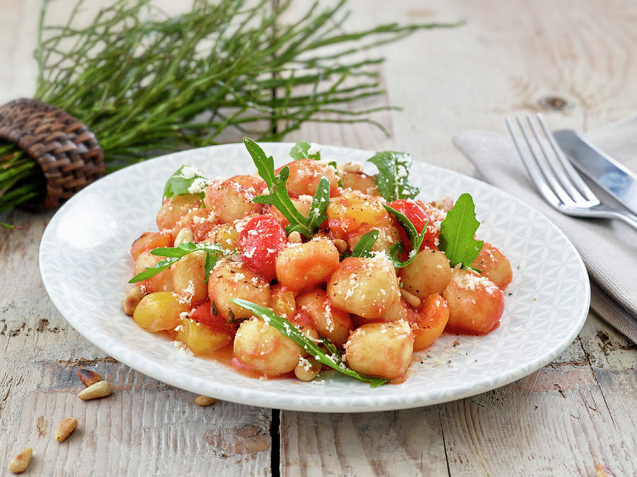 Gnocchi With Tomato Sauce, Rocket And Pine Nuts Photograph by Volker Dautzenberg