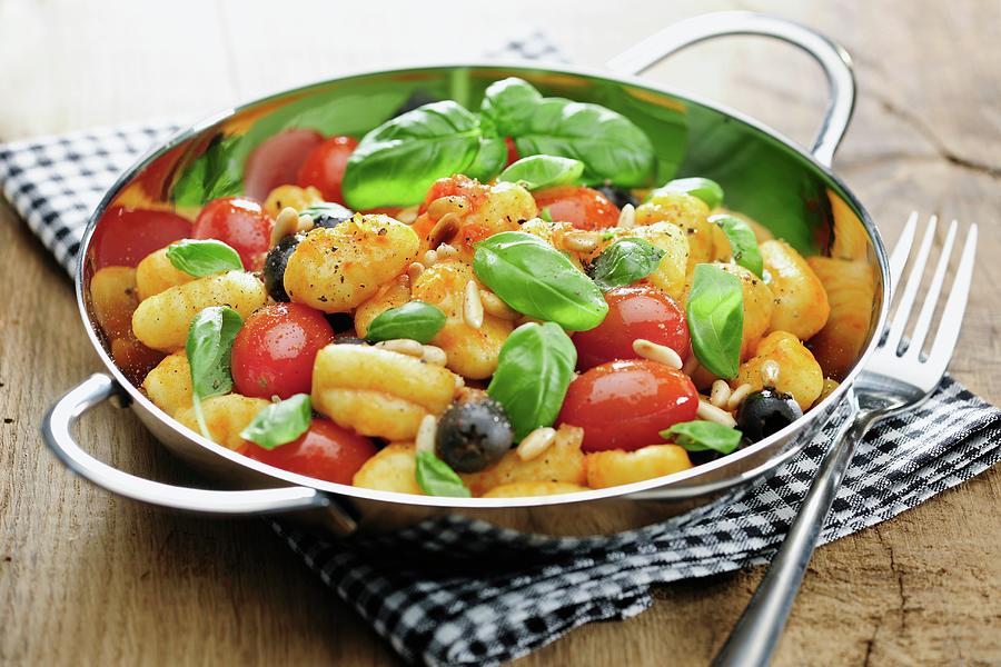 Gnocchi With Tomatoes, Olives, Pine Nuts And Basil Photograph by Ina Peters