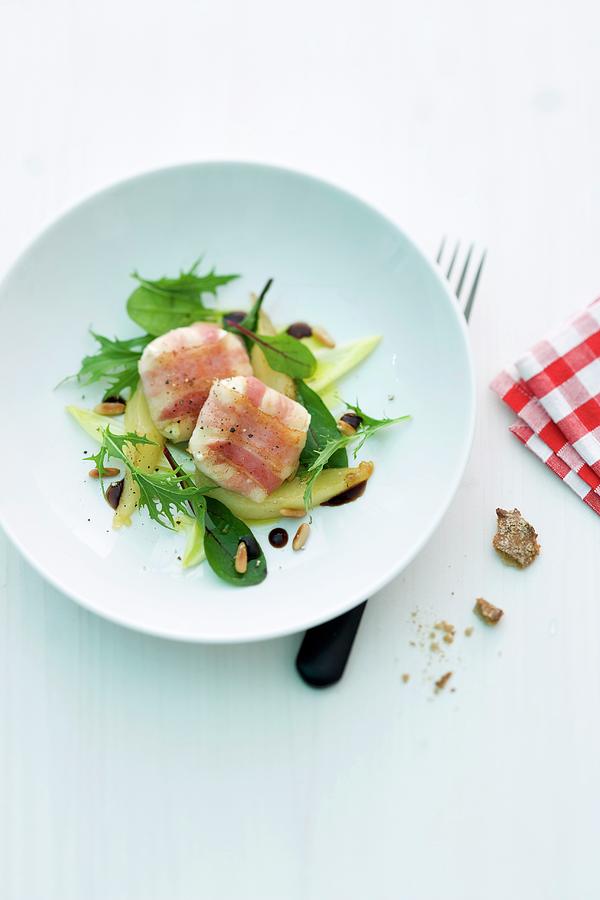 Goats Cheese Wrapped In Bacon On A Mixed Leaf Salad With Pears Photograph by Michael Wissing