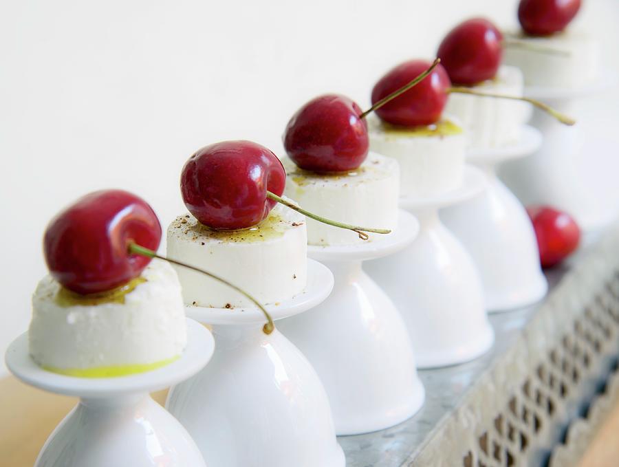 Goats Cream Cheese With Cherries On Upturned Egg Cups Photograph by Katrin Benary