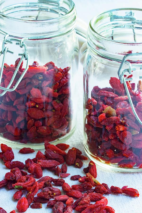 Goji Berries, Lose And In Storage Jars, On A Light Surface Photograph by Charlotte Von Elm