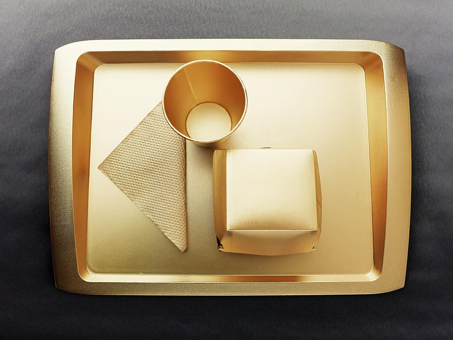 Gold-coloured Disposable Food Set: Tray, Cup, Napkin And Cardboard Box Photograph by Ellert, Luzia