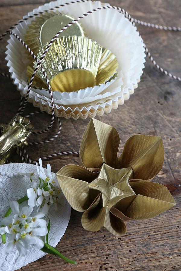 Gold Origami Flowers Next To Paper Cake Cases And Bakers String Photograph by Regina Hippel