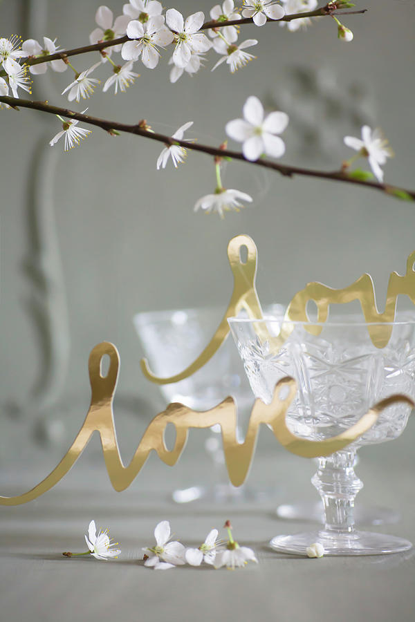 Gold Paper Lettering Reading love In Front Of Old Wine Glasses Photograph by Alicja Koll