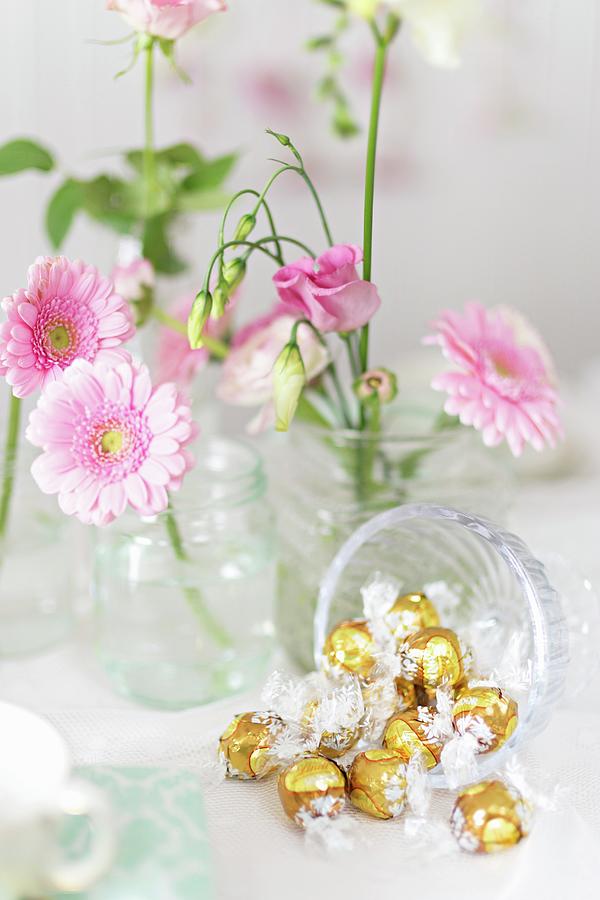 Candy Photograph - Golden Bonbons And Pink Flowers On A Buffet by Cecilia Mller