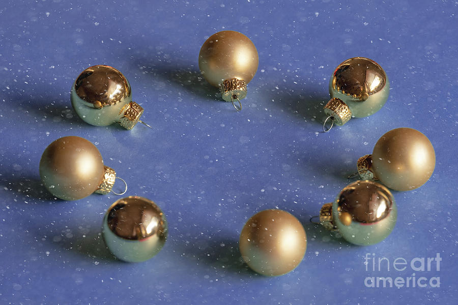 Golden christmas balls on the snowy background Photograph by Marina Usmanskaya
