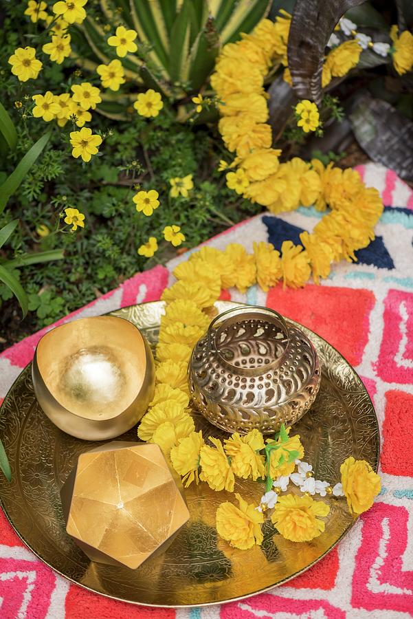 Golden Tealight Holders And Flower Garland On Metal Tray Photograph by Winfried Heinze