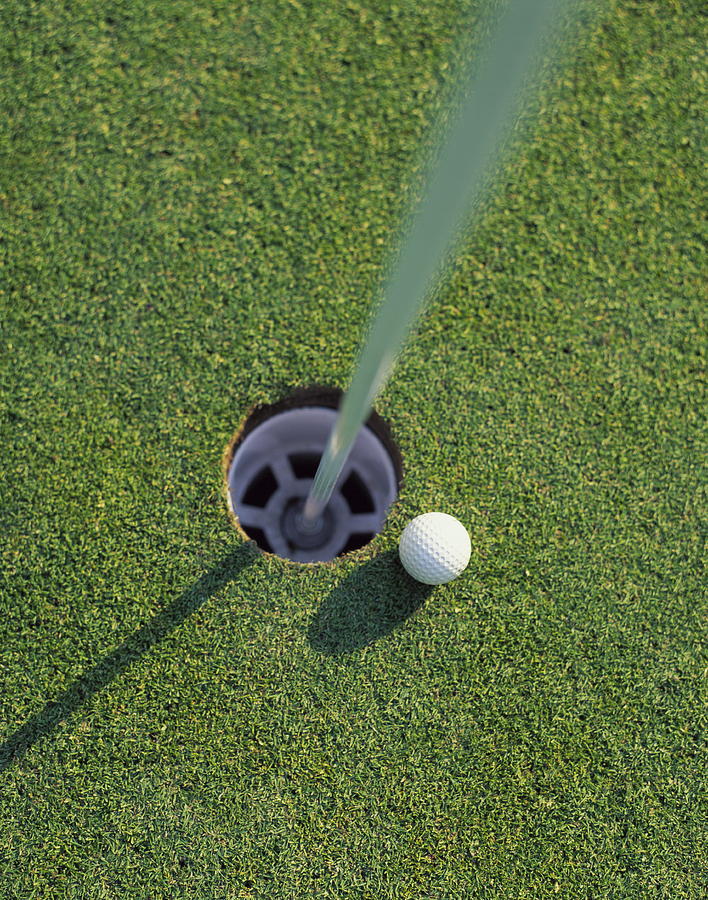 Golf Ball Next To Hole On Golf Course Photograph by Peter Gridley