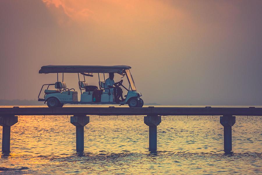 Sunset Photograph - Golf Cart At Maldives Island At Luxury by Levente Bodo