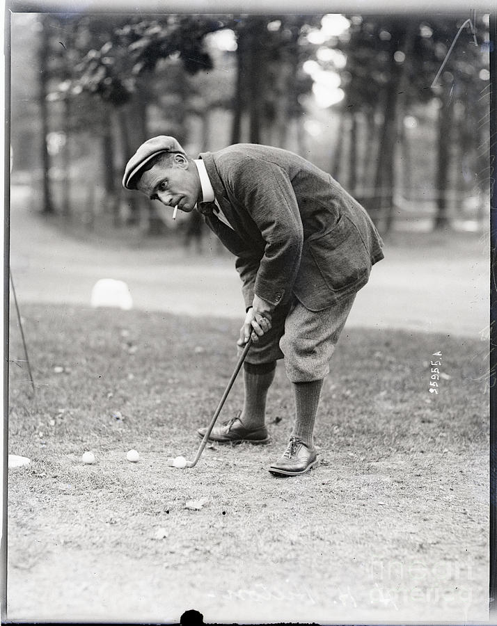 Golfer H. H. Hilton Smokes While Putting Photograph by Bettmann