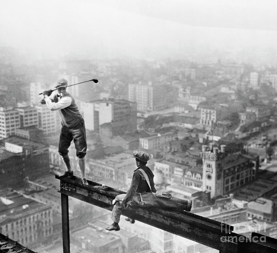 Golfer Teeing Off On Girder High Photograph by Bettmann