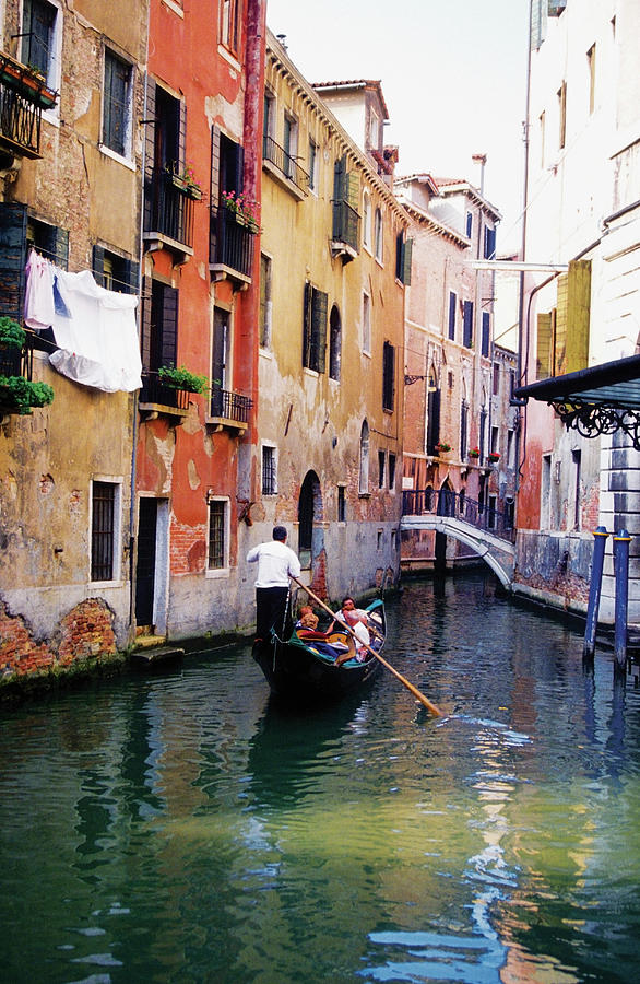 Gondola And Gondolier In A Canal Photograph by Medioimages/photodisc