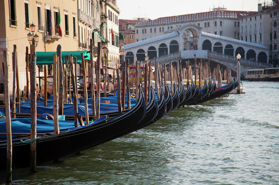 Gondolas Docked On Venice Canal Photograph by Jenny Cundy