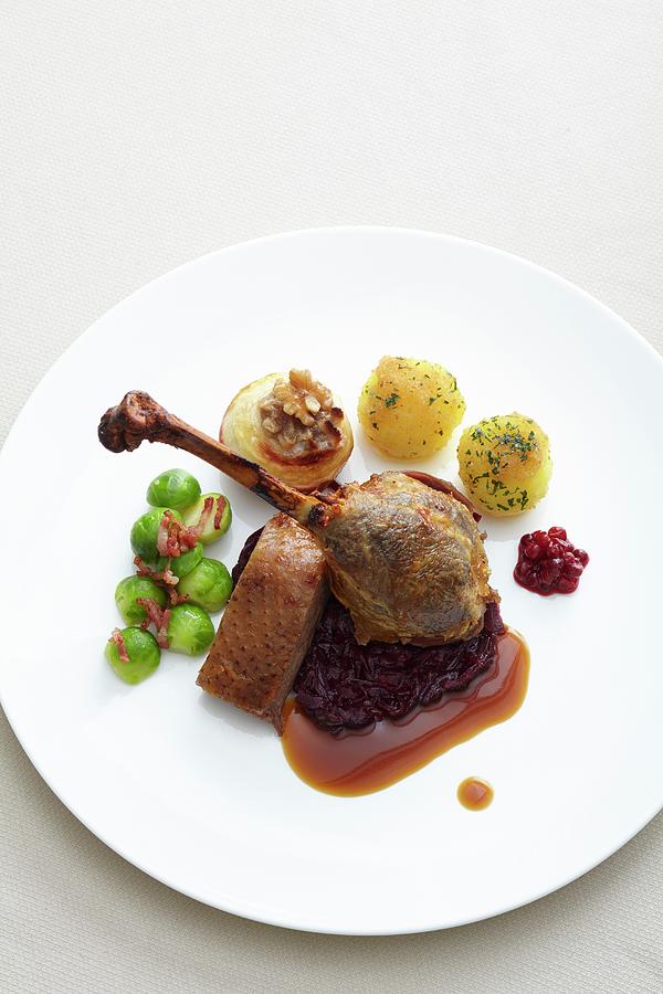 Goose Leg With Red Cabbage, Potato Dumpling, Baked Apples And Brussels Sprouts Photograph by Jalag / Gtz Wrage