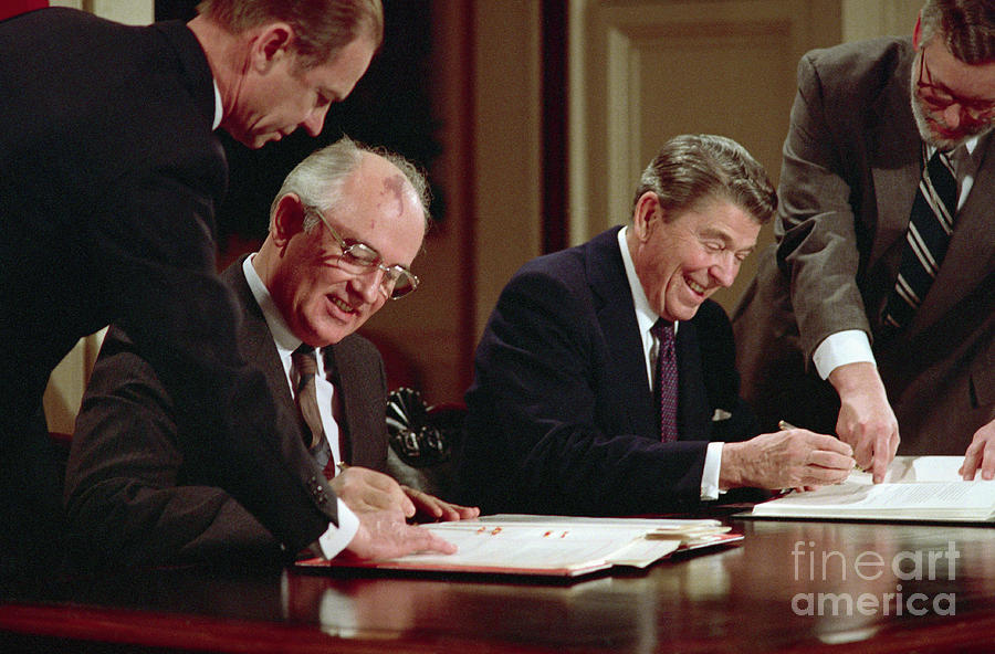 Gorbachev And Reagan Signing Pact Photograph by Bettmann