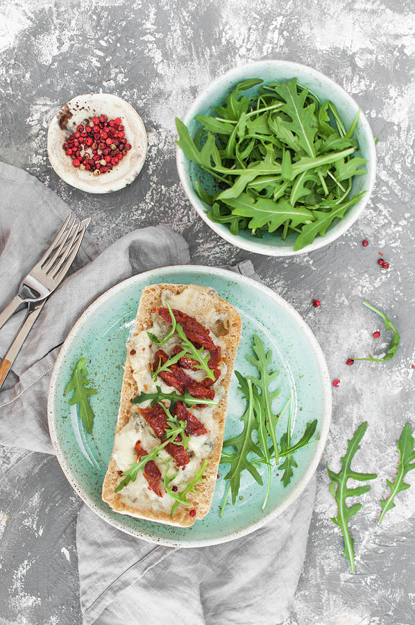Gorgonzola Toast With Sun Dried Tomatoes, Served With Arugula And Pink Pepper Photograph by Kachel Katarzyna