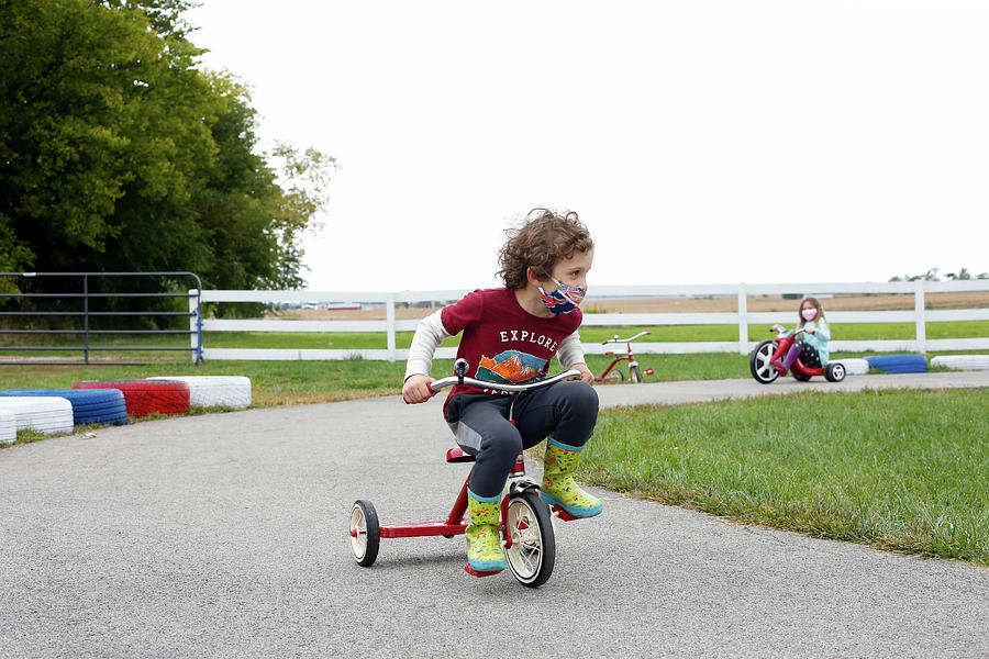 Grade School Boy Riding A Tricycle At An Apple Orchard In The Fall In 