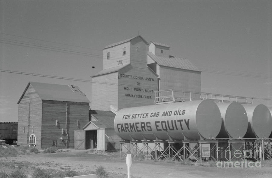 Grain Elevators And Oil Tanks At A Farm In Wolf Point, Montana, 1941 Photograph by Marion Post Wolcott