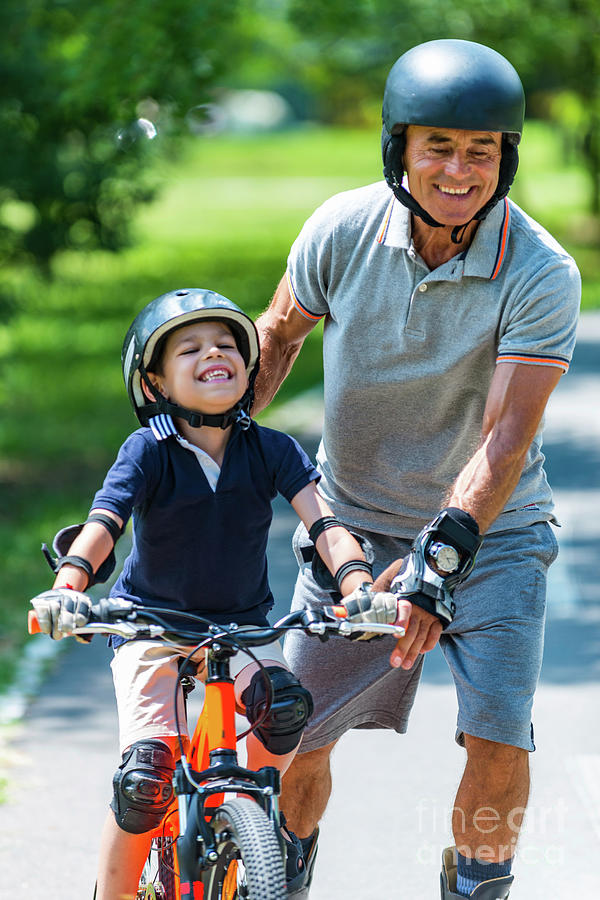 Summer Photograph - Grandfather And Grandson Enjoying Biking And Roller Skating by Microgen Images/science Photo Library