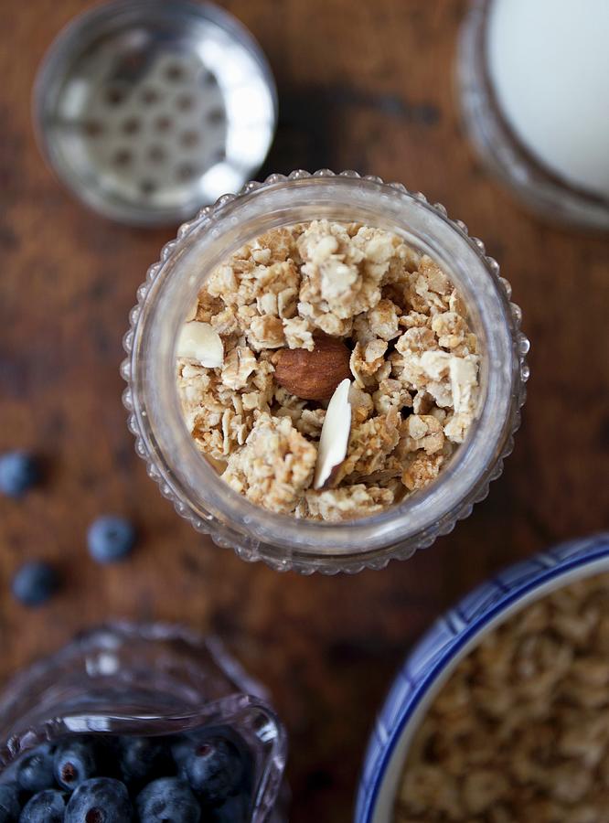 Granola In An Antique Jar, Wild Blueberries In A Glass Jar And Granola In A Bowl Photograph by Ryla Campbell