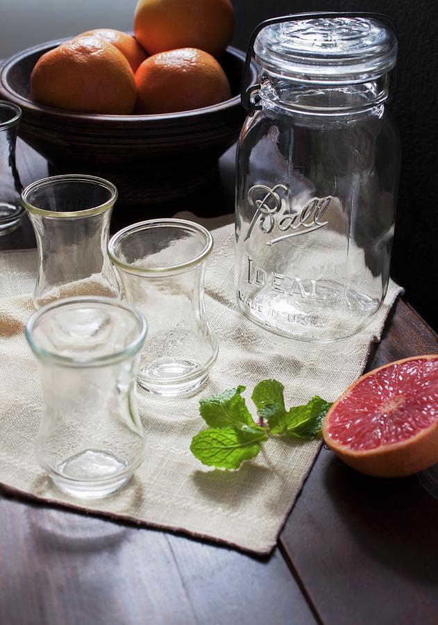 Grapefruits And Empty Glasses Photograph by Katharine Pollak