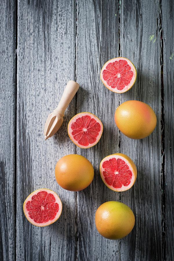 Grapefruits, Whole And Halved Photograph by Great Stock!