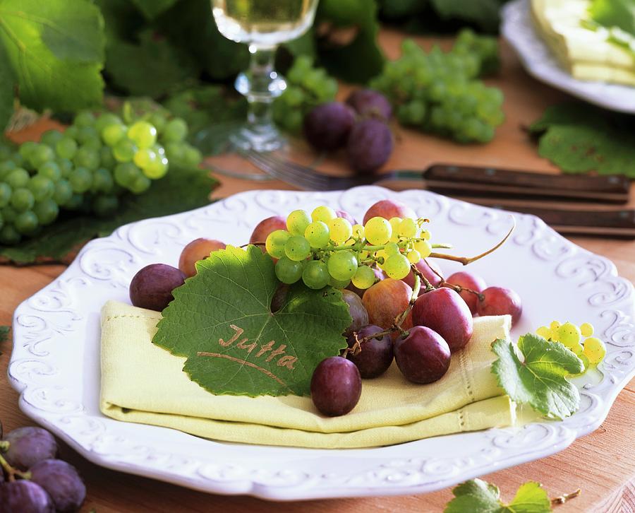 Grapes And Vine Leaf As Place Card On Napkin Photograph by Strauss, Friedrich