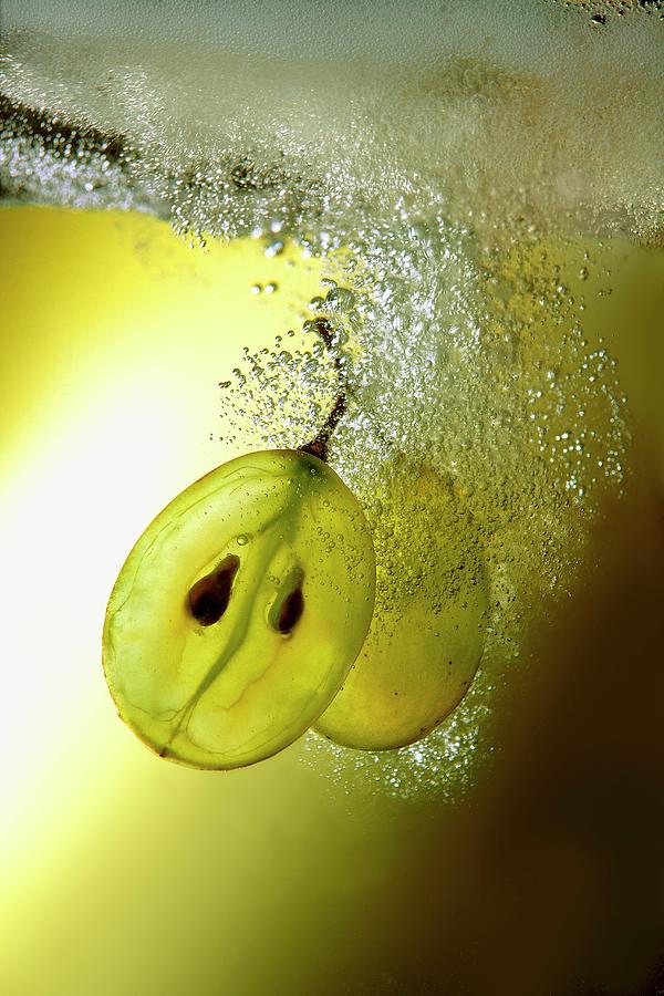 Grapes Sinking Through Sparkling Wine Photograph by Schieren, Bodo A.