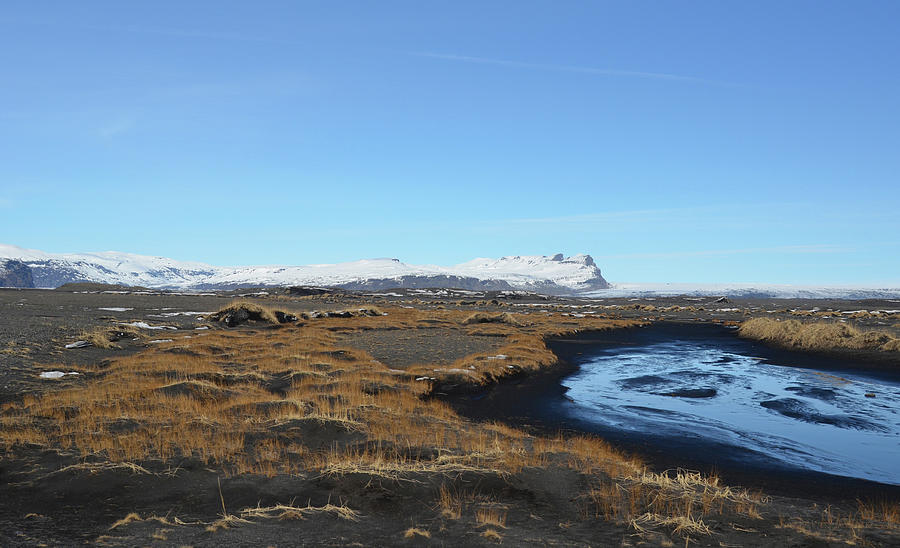 Grass and Stream over Black Lava Field Under Clear Sky Iceland Photograph by Shawn OBrien