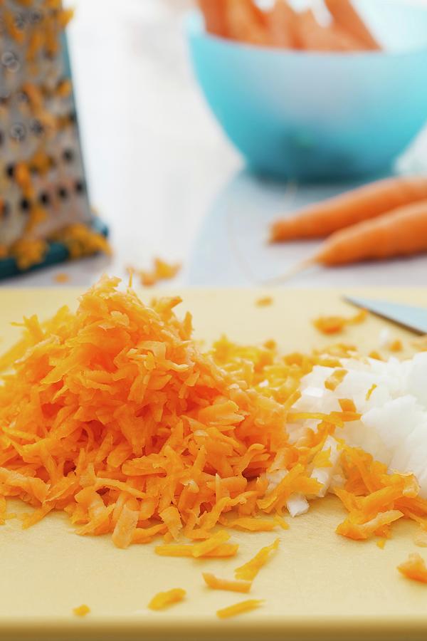 Grated Carrots And Diced Onions On A Cutting Board Photograph by Yelena Strokin
