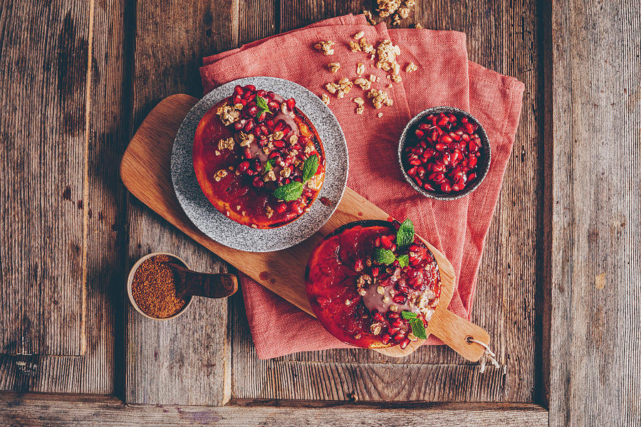 Gratinated Grapefruit Halves With Yoghurt, Muesli, Pomegranate Seeds And Mint Leaves Photograph by Freistyle