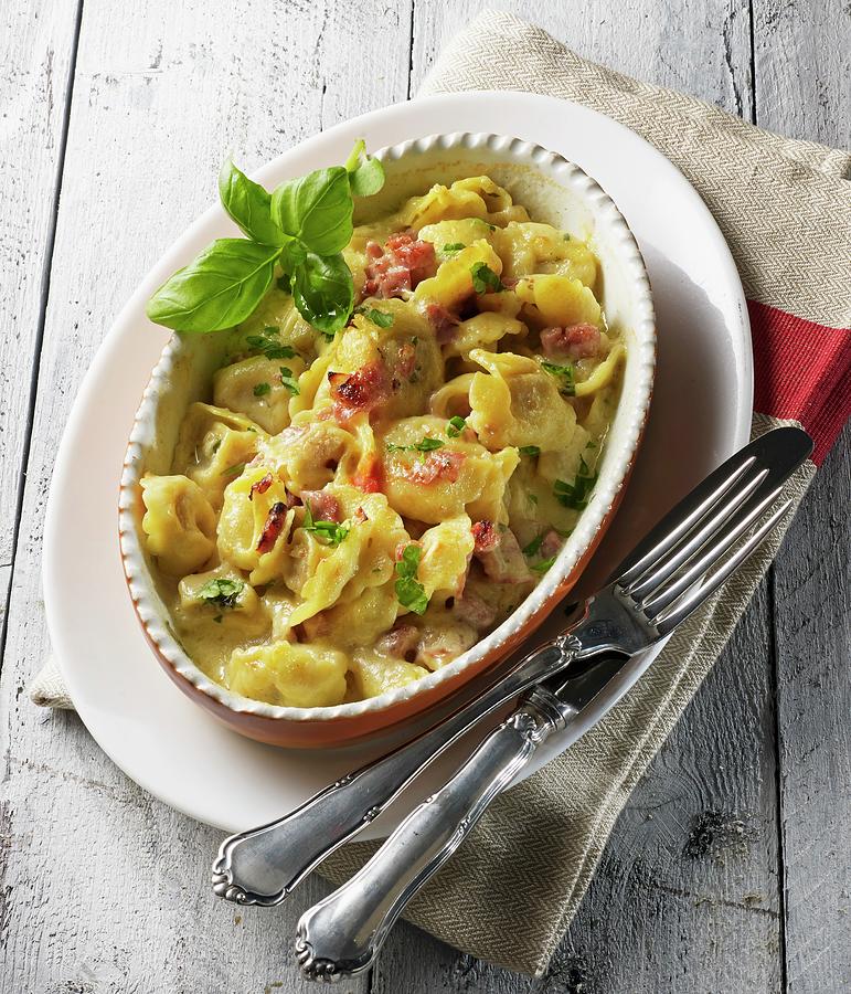 Gratinated Tortellini With A Creamy Ham Sauce And Basil Photograph by Ludger Rose