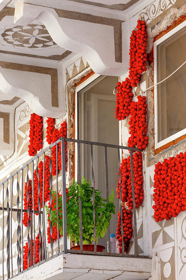 Greek Digital Art - Greece, Aegean Islands, Chios Island, Mediterranean Sea, Aegean Sea, Greek Islands, Pyrgi, Decorated Houses In The Village With Cherry Tomatoes Hanging On A Wall At The Sun by Giorgio Filippini