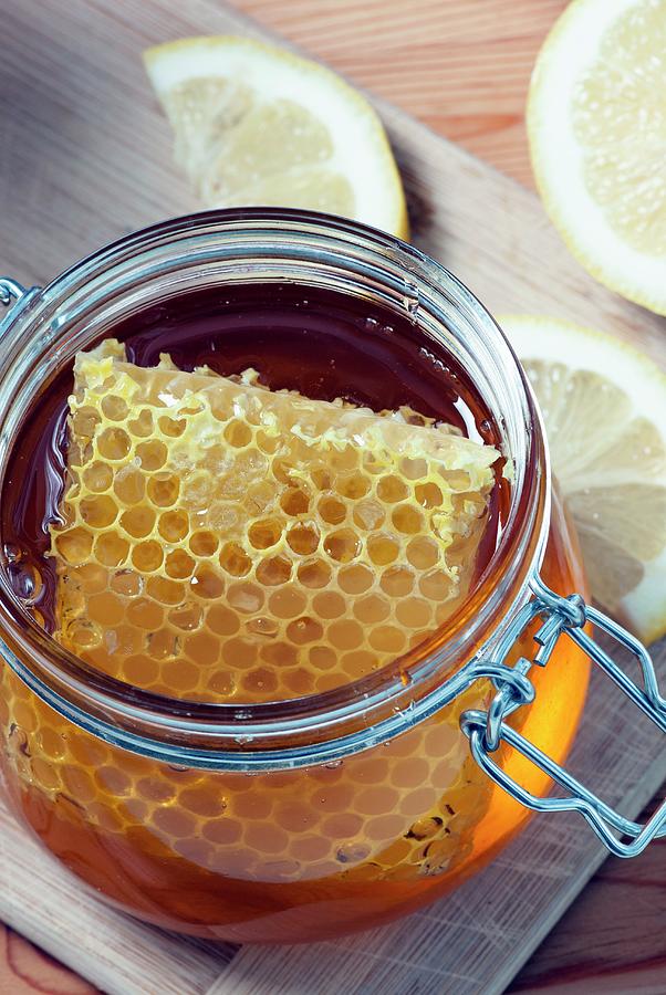 Greek Organic Honey With Honeycomb In A Glass Jar Photograph by Spyros Bourboulis