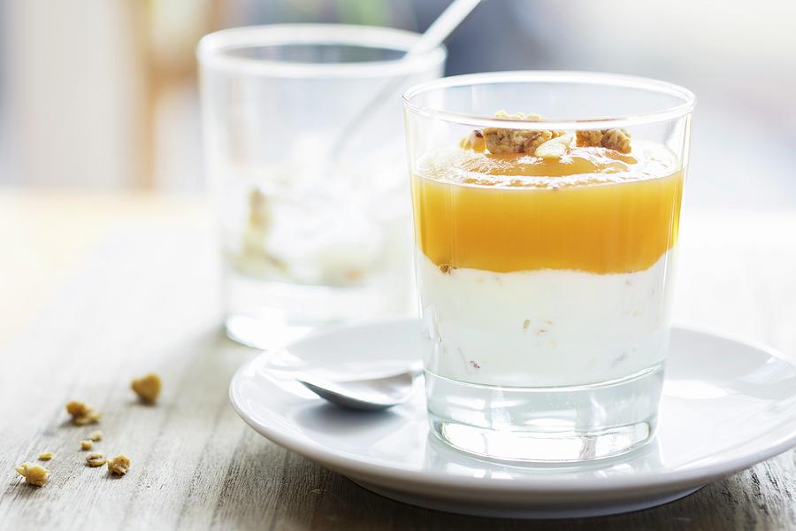 Greek Yoghurt With Crunchy Muesli And Homemade Apple Sauce In A Glass Photograph by Jan Wischnewski