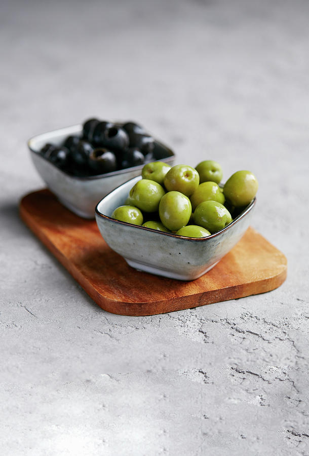 Green And Black Olives In Small Bowls Photograph by Rafael Pranschke