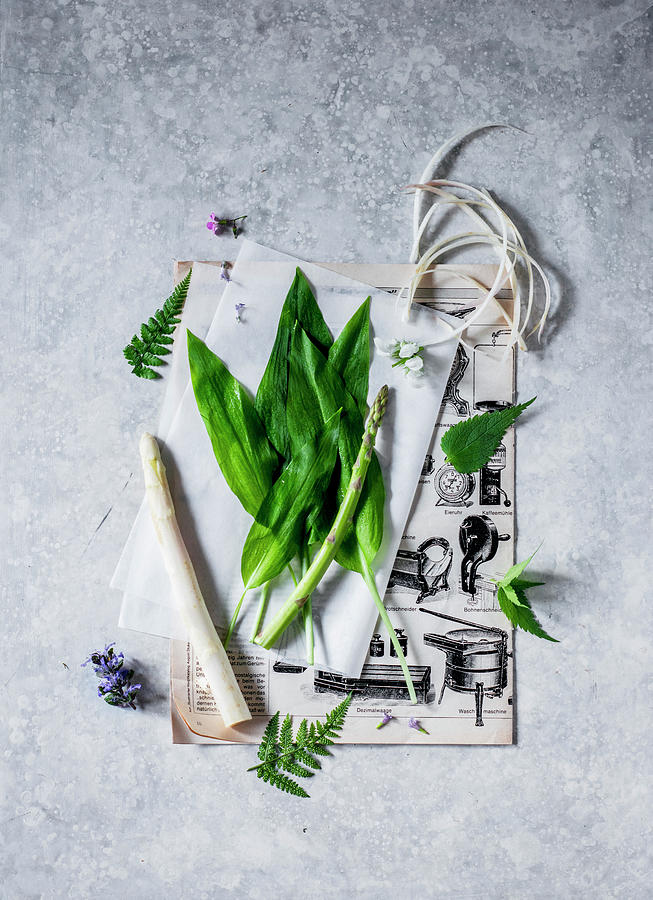 Green And White Asparagus And Wild Garlic On Parchment Paper Photograph by Carolin Strothe