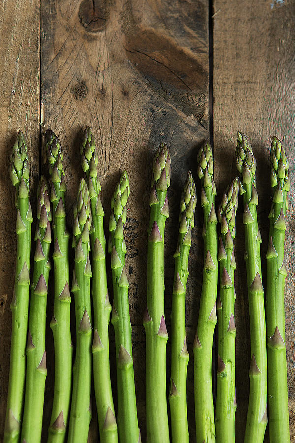 Green Asparagus Spears On A Wooden Background top View Photograph by Stacy Grant