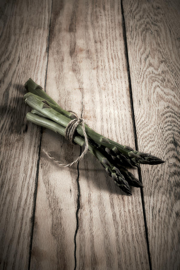 Green Asparagus Spears Tied Together On A Wooden Background Photograph by Shawn Driman Photography