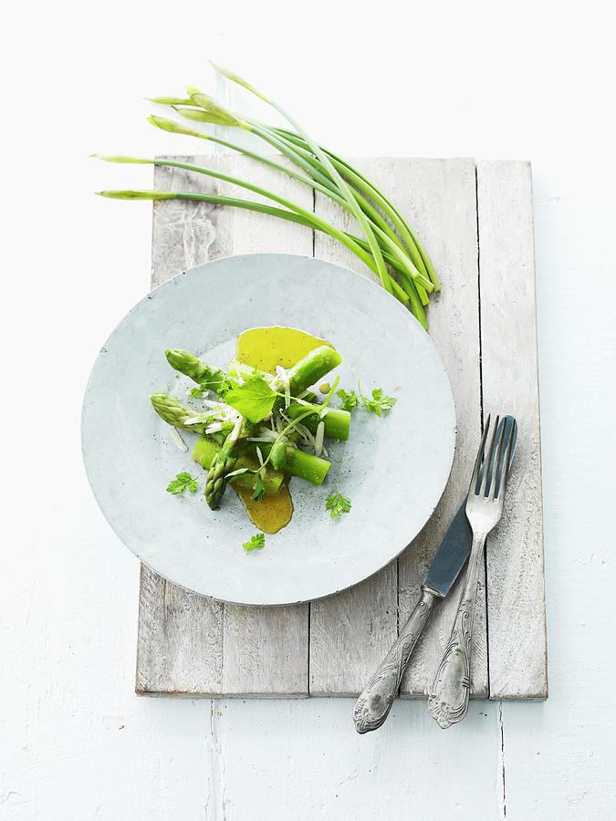 Green Asparagus With Olive Oil And Garlic Chives For Easter Photograph by Lars Ranek