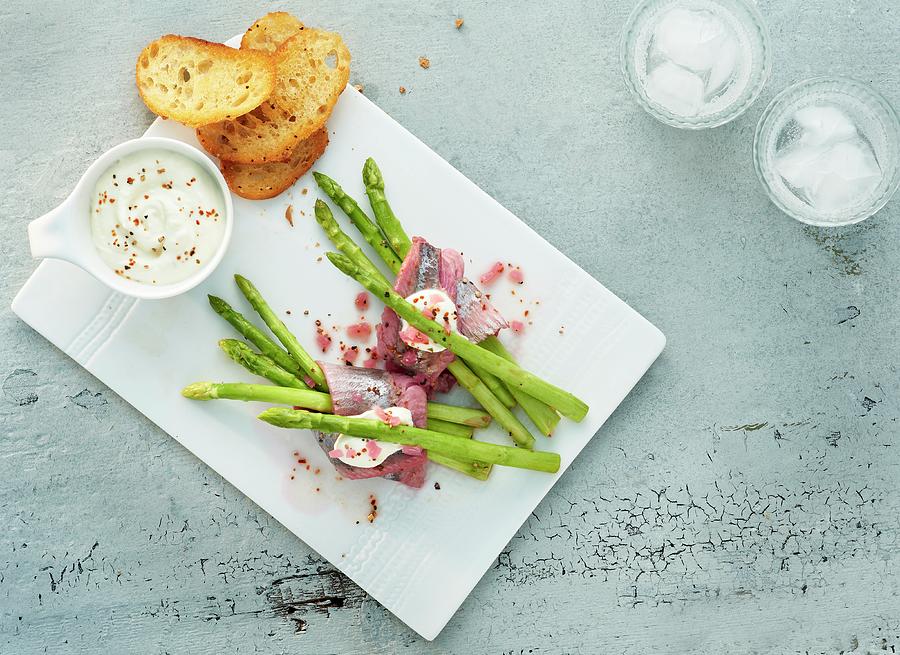 Green Asparagus With Sherry Soaked Herring And Toasted Bread Slices Photograph by Stefan Schulte-ladbeck