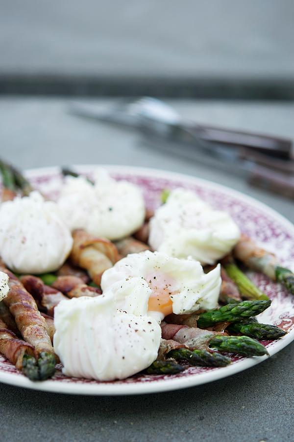 Green Asparagus Wrapped In Bacon With Eggs Benedict Photograph by Justina Ramanauskiene