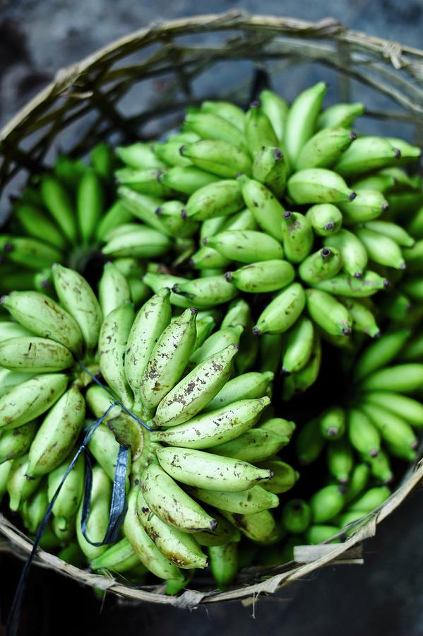 Green Bananas In A Basket At A Market In Bali Photograph by Oliver Brachat