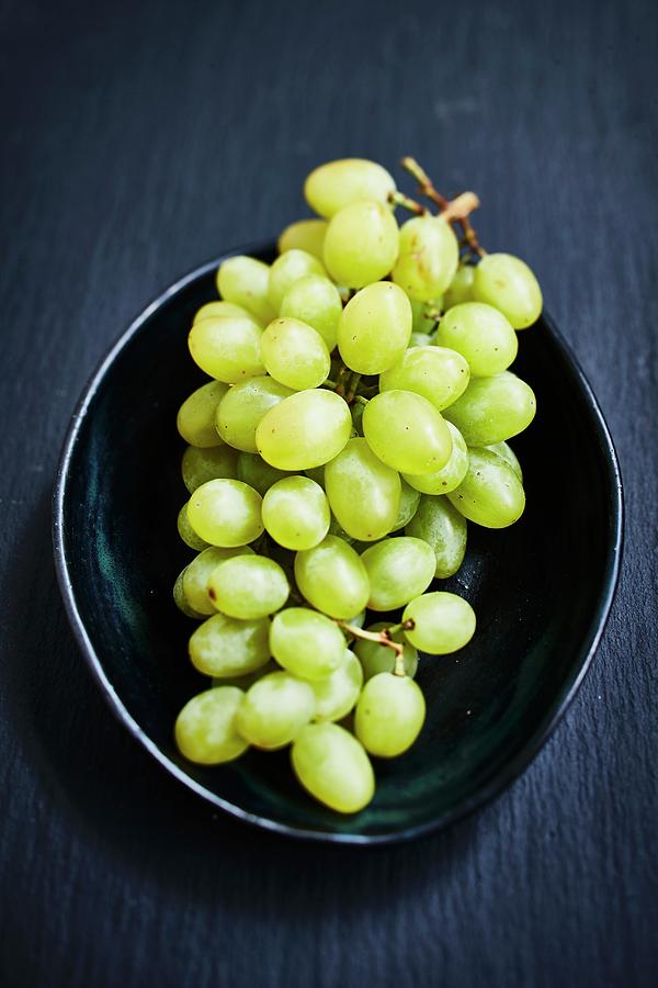 Green Grapes In A Bowl On A Dark Background Photograph by Brigitte Sporrer