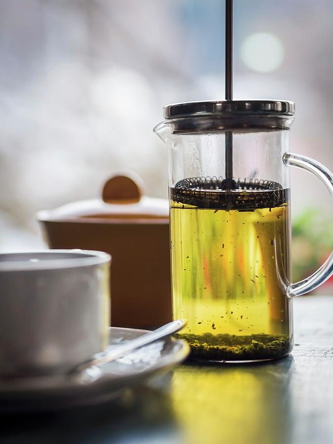 Green Jasmine Tea In A Cup And In A Tea Press Photograph by Magdalena Paluchowska