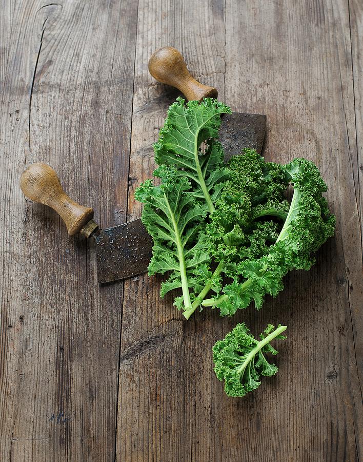Green Kale With A Mezzaluna Photograph by Ewgenija Schall