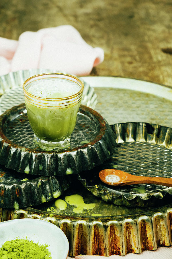 Green Matcha Latte In A Little Glass On Baking Trays Photograph by Lucie Beck