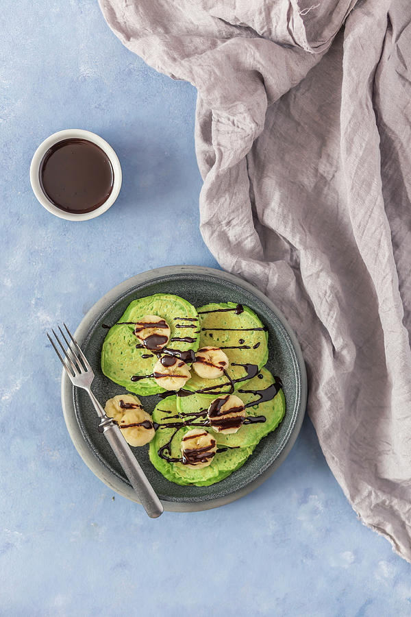 Green Pancakes With Banana And Chocolate Sauce Photograph by Malgorzata Laniak